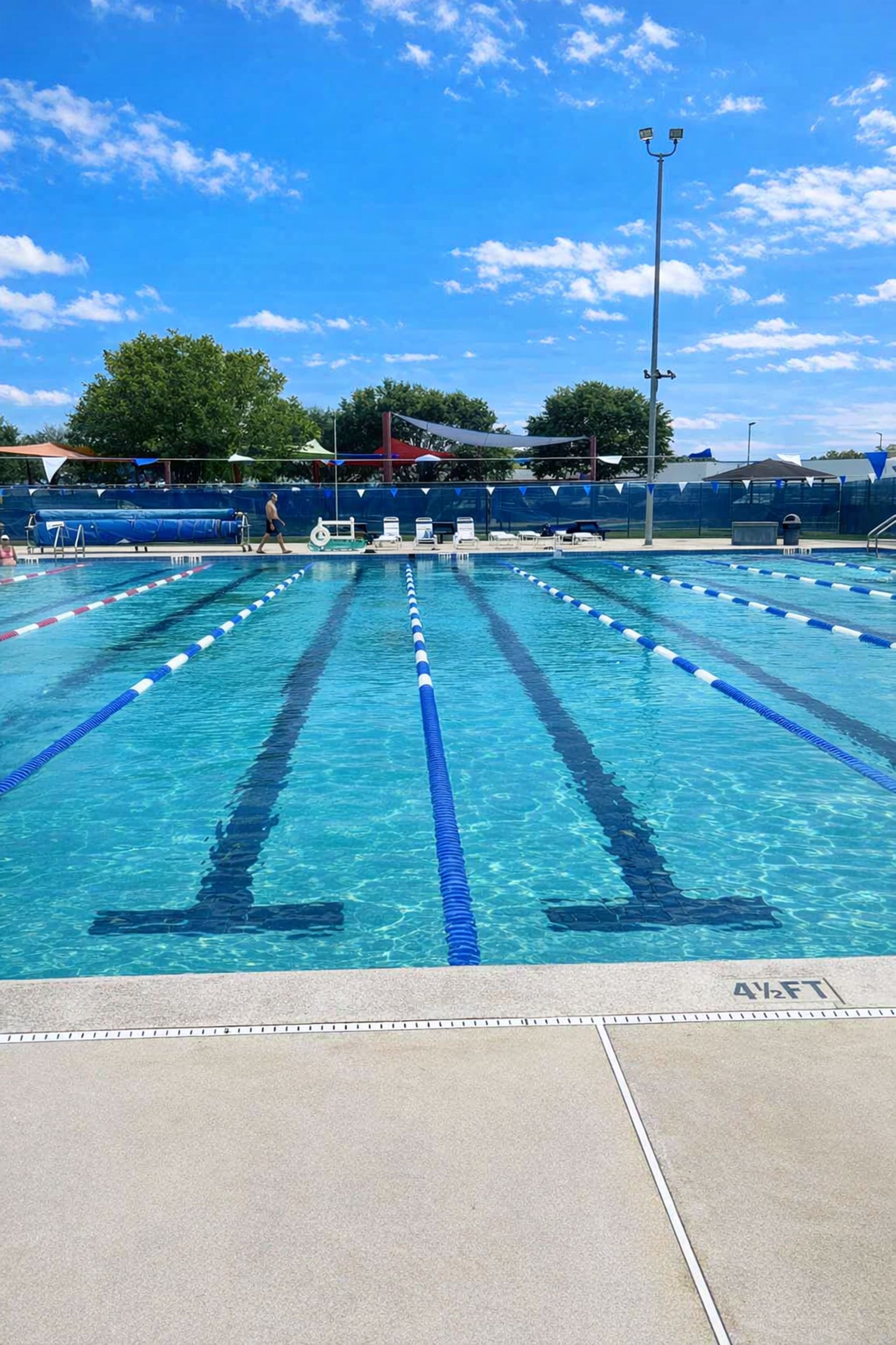 25-meter outdoor lap pool at the Palm Coast Aquatics Center with lane dividers under blue sky